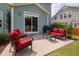 Cozy patio space with red cushioned seating and a barbecue grill at 42 Village Walk Dr, Chapel Hill, NC 27517
