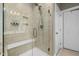 Shower with glass enclosure, bench seating, and tile surround, offering a modern and luxurious bathing space at 42 Village Walk Dr, Chapel Hill, NC 27517