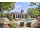 Beautiful backyard with a refreshing pool, screened porch, patio, and lush landscaping at 423 N Cameron St, Hillsborough, NC 27278