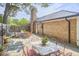 Charming backyard with brick home, featuring patio dining set and outdoor lounge area at 423 N Cameron St, Hillsborough, NC 27278