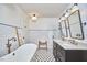 Bright bathroom featuring a tub, and flower-patterned tile floor at 423 N Cameron St, Hillsborough, NC 27278