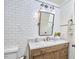 Bathroom vanity with marble top, rustic wood cabinets, and white subway tile at 423 N Cameron St, Hillsborough, NC 27278