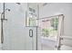 Elegant bathroom featuring white tile, glass shower, and black and white mosaic tile floor at 423 N Cameron St, Hillsborough, NC 27278