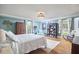 Stylish bedroom with hardwood floors, a cozy chair, and large windows at 423 N Cameron St, Hillsborough, NC 27278