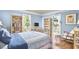 Cozy bedroom with light blue walls, hardwood floors, and lots of natural light at 423 N Cameron St, Hillsborough, NC 27278