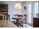 Dining room with wood floors and traditional wood table set with natural light streaming through windows at 423 N Cameron St, Hillsborough, NC 27278