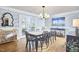 Dining room with wood floors, a table set for eight, and a view of the outdoor patio at 423 N Cameron St, Hillsborough, NC 27278