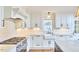 Modern kitchen featuring white cabinets, sleek countertops, and a gas range, perfect for cooking enthusiasts at 423 N Cameron St, Hillsborough, NC 27278
