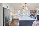Bright kitchen with stainless steel appliances, white cabinetry, and an island with seating at 423 N Cameron St, Hillsborough, NC 27278