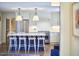Kitchen island with barstools overlooking kitchen with stainless steel appliances and white cabinets at 423 N Cameron St, Hillsborough, NC 27278