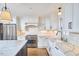 Bright kitchen features white cabinets, stainless steel appliances, and marble countertops at 423 N Cameron St, Hillsborough, NC 27278