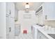 Well-organized laundry room features white cabinets, marbled countertops, and modern washer/dryer at 423 N Cameron St, Hillsborough, NC 27278