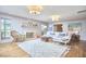 Sunlit living room with fireplace, sofa, hardwood floors and area rug at 423 N Cameron St, Hillsborough, NC 27278