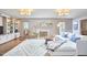 Bright living room with hardwood floors, fireplace, built-in shelving, and an area rug at 423 N Cameron St, Hillsborough, NC 27278