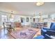 Open-concept living space boasts wood floors, a cozy seating area, and kitchen island with barstools at 423 N Cameron St, Hillsborough, NC 27278