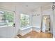 Bright mudroom with built-in bench, ample natural light from the window, and wood floors at 423 N Cameron St, Hillsborough, NC 27278