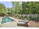 Serene pool area with lounge chairs and lush landscaping, perfect for relaxing and enjoying the outdoors at 423 N Cameron St, Hillsborough, NC 27278