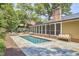 A beautiful in-ground pool with a brick surround and screened porch at 423 N Cameron St, Hillsborough, NC 27278