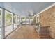 Inviting screened porch with comfortable seating and view to the backyard and pool at 423 N Cameron St, Hillsborough, NC 27278