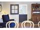 A sitting room with blue chairs, hardwood floors and a quaint blue dutch door at 423 N Cameron St, Hillsborough, NC 27278