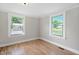 Bright bedroom with wood floors and natural light from two windows at 441 Cedar St, Henderson, NC 27536