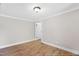 Cozy bedroom with painted walls, durable wood-look flooring, and a partially open doorway at 441 Cedar St, Henderson, NC 27536