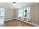 Bedroom with natural light and wood look laminate flooring at 441 Cedar St, Henderson, NC 27536