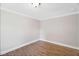 Simple bedroom featuring wood-look floors, painted trim, and neutral walls with room for personalization at 441 Cedar St, Henderson, NC 27536