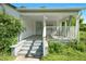 Welcoming front porch featuring steps, railings, and an exterior entryway at 441 Cedar St, Henderson, NC 27536