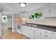 Kitchen featuring white cabinets and a view to the outside at 441 Cedar St, Henderson, NC 27536