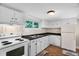 Classic kitchen with white cabinets, black countertops, and a vintage stove at 441 Cedar St, Henderson, NC 27536