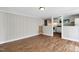 Open-concept living room with wood floors and a view into the kitchen at 441 Cedar St, Henderson, NC 27536
