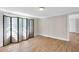 Spacious living room featuring wood floors and a decorative folding screen near a window at 441 Cedar St, Henderson, NC 27536