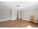 Inviting room with wood floors, neutral walls, and doorway to the kitchen at 441 Cedar St, Henderson, NC 27536