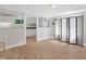 Open living room with wood floors flowing into a kitchen with white cabinetry at 441 Cedar St, Henderson, NC 27536