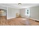 Bright living room with wood floors, a chair, and a view into the kitchen at 441 Cedar St, Henderson, NC 27536
