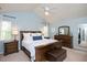 This primary bedroom boasts a ceiling fan, an upholstered bench, and a full ensuite bath for convenience and comfort at 4520 Timberhurst Dr, Raleigh, NC 27612