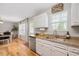 White cabinets, stainless steel appliances, and granite countertops create an elegant kitchen design at 4520 Timberhurst Dr, Raleigh, NC 27612