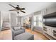 Cozy living room with hardwood floors, comfortable seating arrangement, and large windows at 4520 Timberhurst Dr, Raleigh, NC 27612