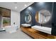Modern bathroom featuring a soaking tub and marble accent wall with floating vanities at 4908 Birchleaf Dr, Raleigh, NC 27606