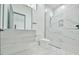 Modern bathroom with marble tile, glass enclosed shower, and sleek vanity with storage at 4908 Birchleaf Dr, Raleigh, NC 27606