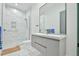 Modern bathroom with white marble, featuring a walk-in shower and modern vanity at 4908 Birchleaf Dr, Raleigh, NC 27606