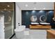 Modern bathroom featuring a soaking tub and marble accent wall with floating vanities at 4908 Birchleaf Dr, Raleigh, NC 27606