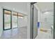 Spacious bedroom with outdoor access, and features a luxurious en suite bathroom with marble walk-in shower at 4908 Birchleaf Dr, Raleigh, NC 27606