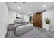 Modern bedroom with a gray color scheme, rug, and attached bathroom at 4908 Birchleaf Dr, Raleigh, NC 27606