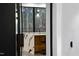 Modern home entrance with black door opening to view the open-concept kitchen and large windows at 4908 Birchleaf Dr, Raleigh, NC 27606