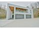 Modern home exterior boasts clean lines, a wood-accented overhang, and a spacious three-car garage at 4908 Birchleaf Dr, Raleigh, NC 27606
