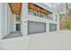 Modern home exterior with a balcony, two-car garage, wood details and a stylish, minimalist design at 4908 Birchleaf Dr, Raleigh, NC 27606