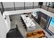 Modern open-concept interior featuring a long island with seating, stainless steel refrigerator, and view of pool at 4908 Birchleaf Dr, Raleigh, NC 27606
