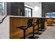 Modern kitchen island with bar stool seating and sleek cabinets at 4908 Birchleaf Dr, Raleigh, NC 27606